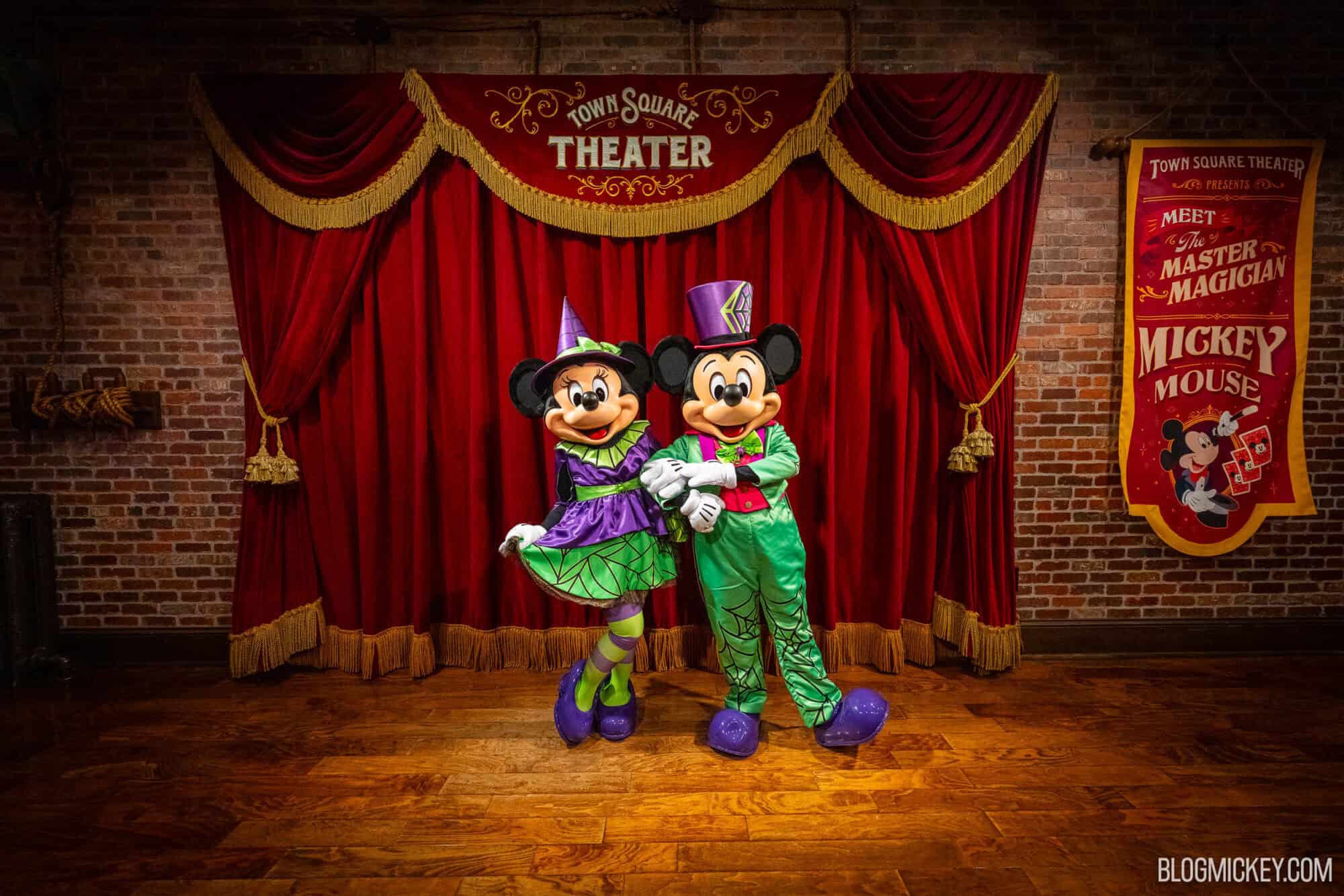 Colorful Disney characters Mickey and Minnie Mouse in Halloween costumes at Town Square Theater.