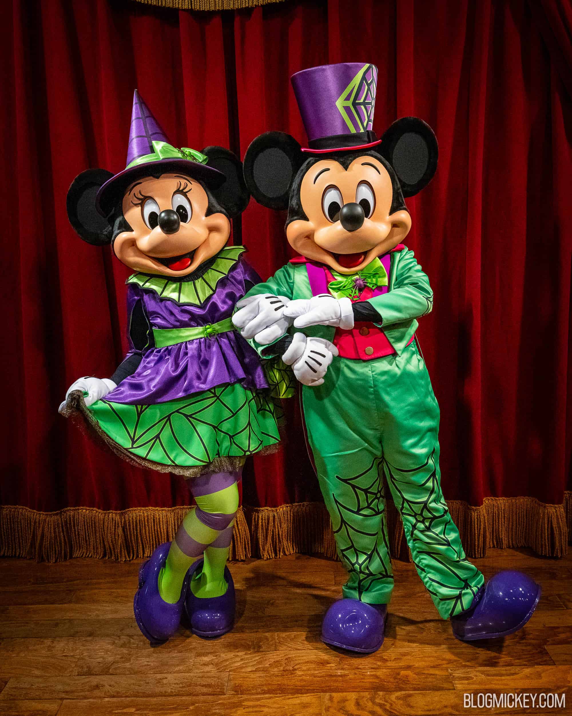 Colorful Disney characters Mickey and Minnie Mouse in Halloween costumes at Town Square Theater.