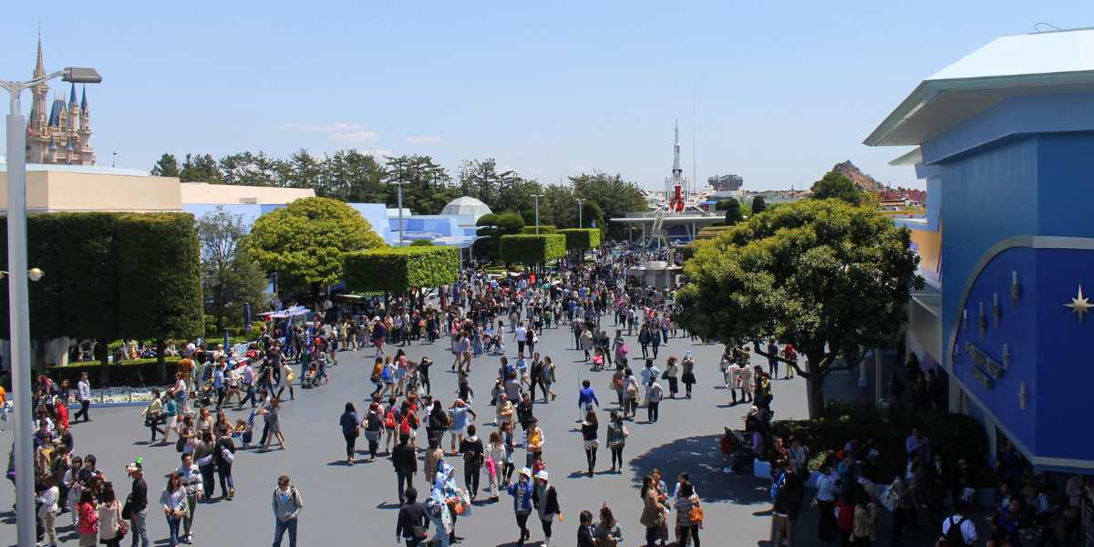 Guests walk through Tomorrowland at Tokyo Disneyland, where guests can ride The Happy Ride with Baymax.