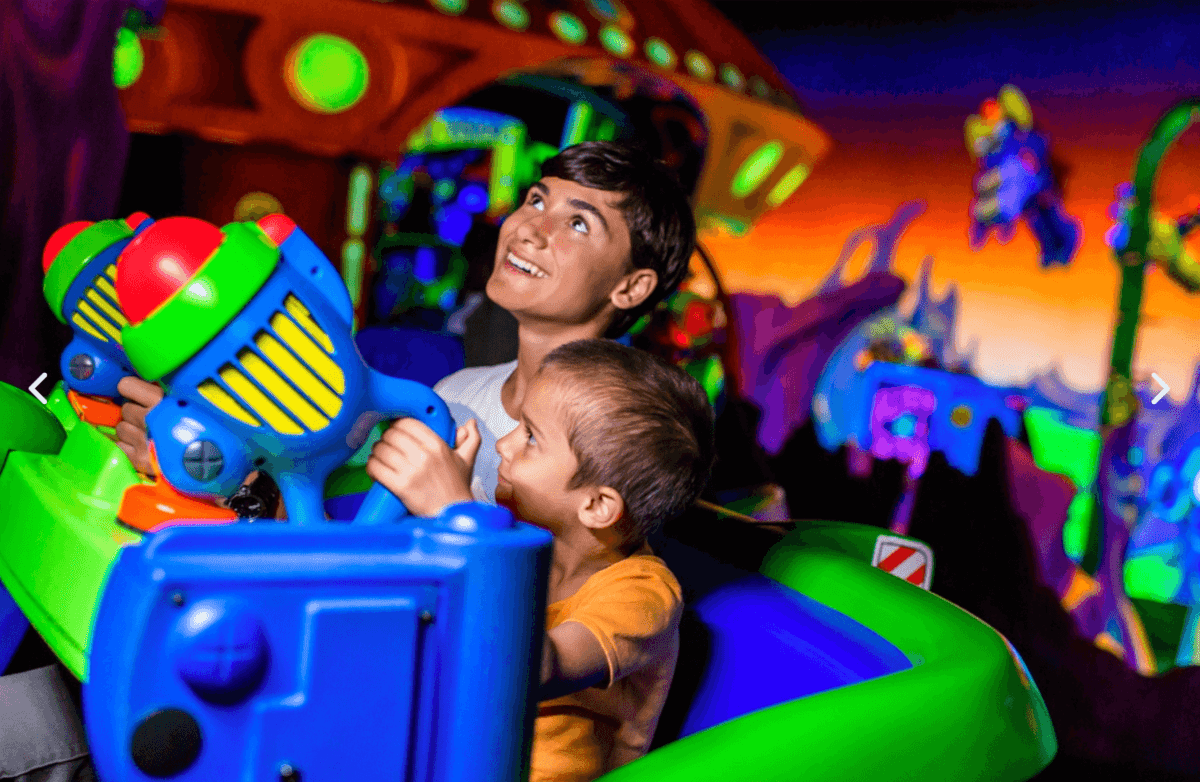 two boys on buzz lightyear's space ranger spin