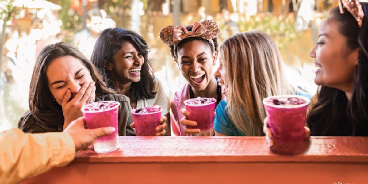 Women drink at Disney California Adventure Food and Wine at Disneyland at this Californian Disney Resort.