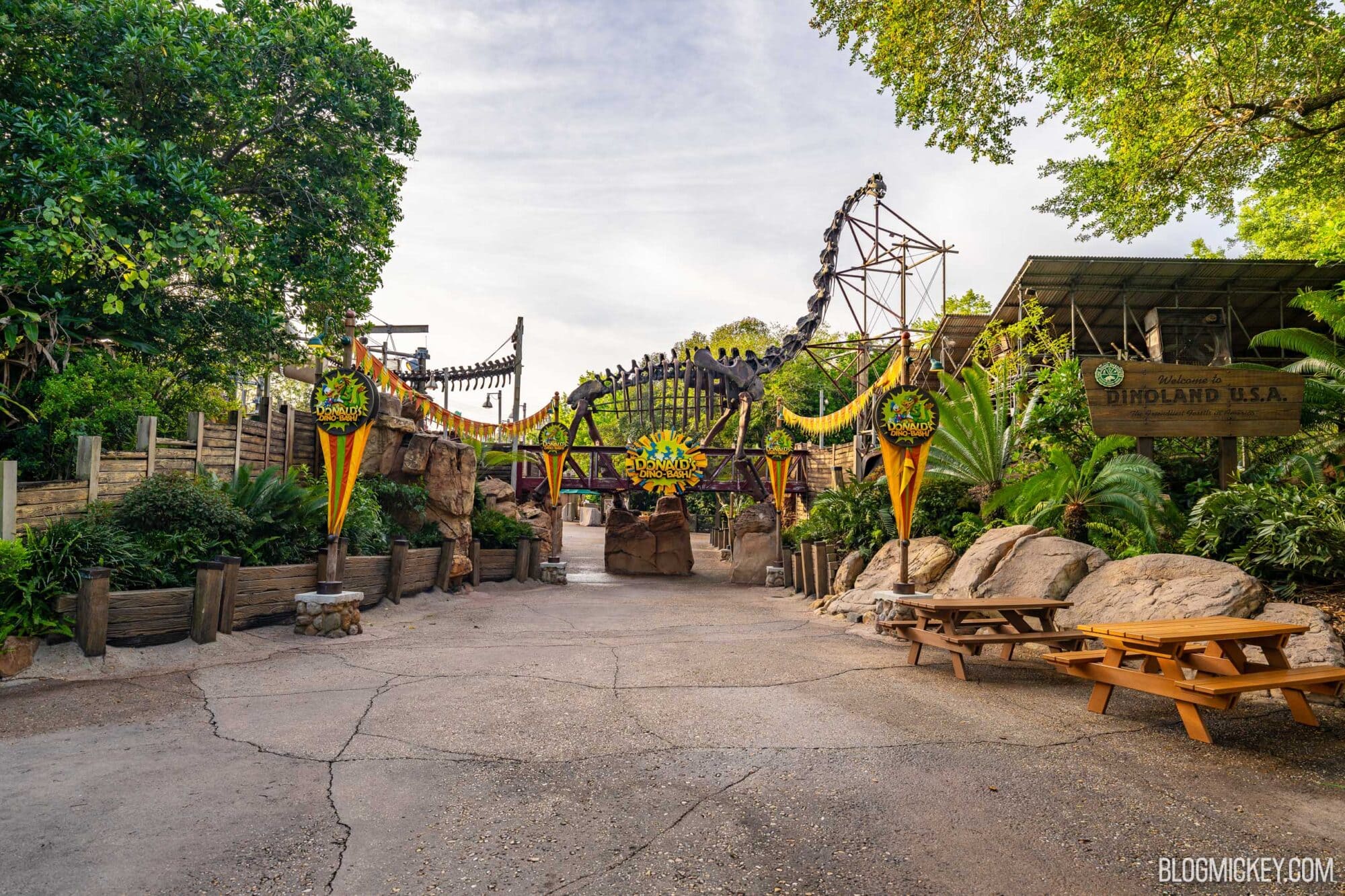 Dinosaur-themed area at Disney's Animal Kingdom with a large dinosaur skeleton connected to a bridge as the entry into the themed area