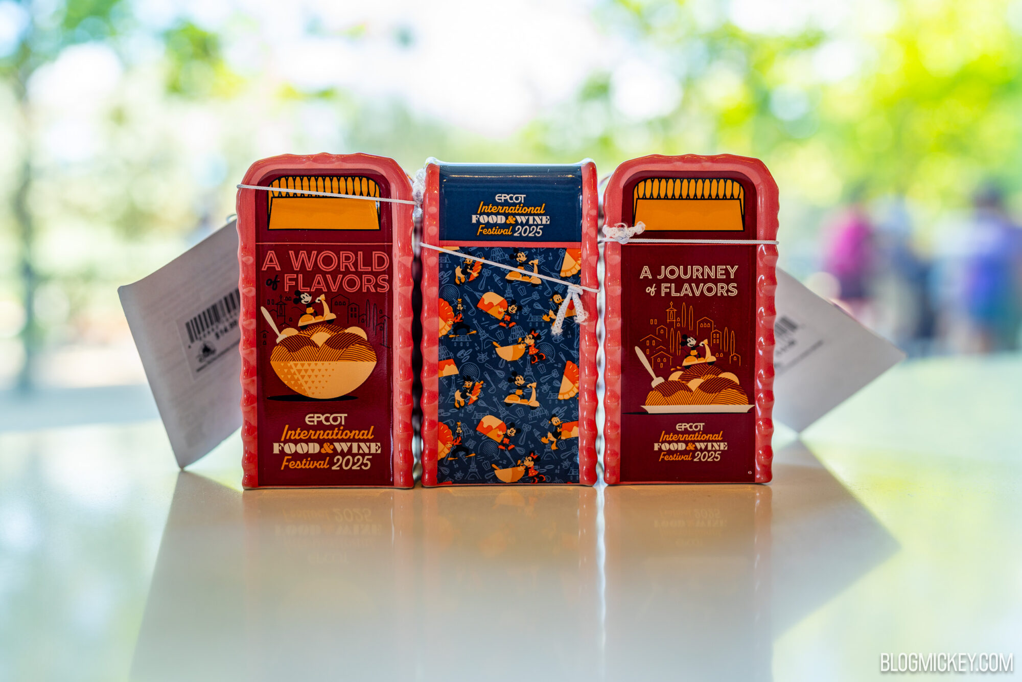 Colorful mini trash cans for EPCOT's International Food & Wine Festival 2025, showcasing Disney characters and festival branding.