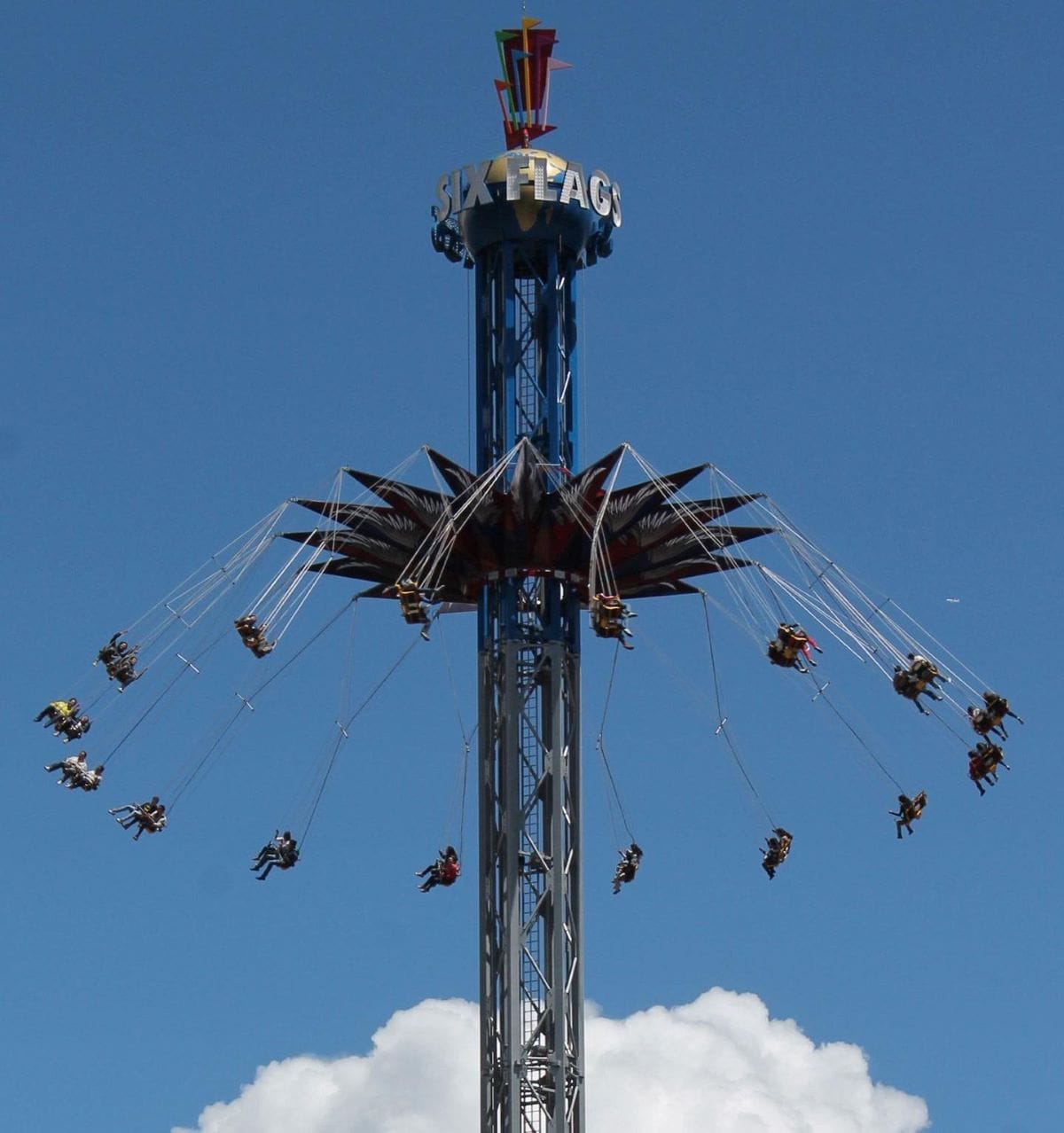 Supergirl Sky Flight, a high-speed thrill ride that spins guests at 64 kilometers per hour in Six Flags Mexico. The attraction is a 240-feet blue tower with Supergirl's logo on top and flying swings