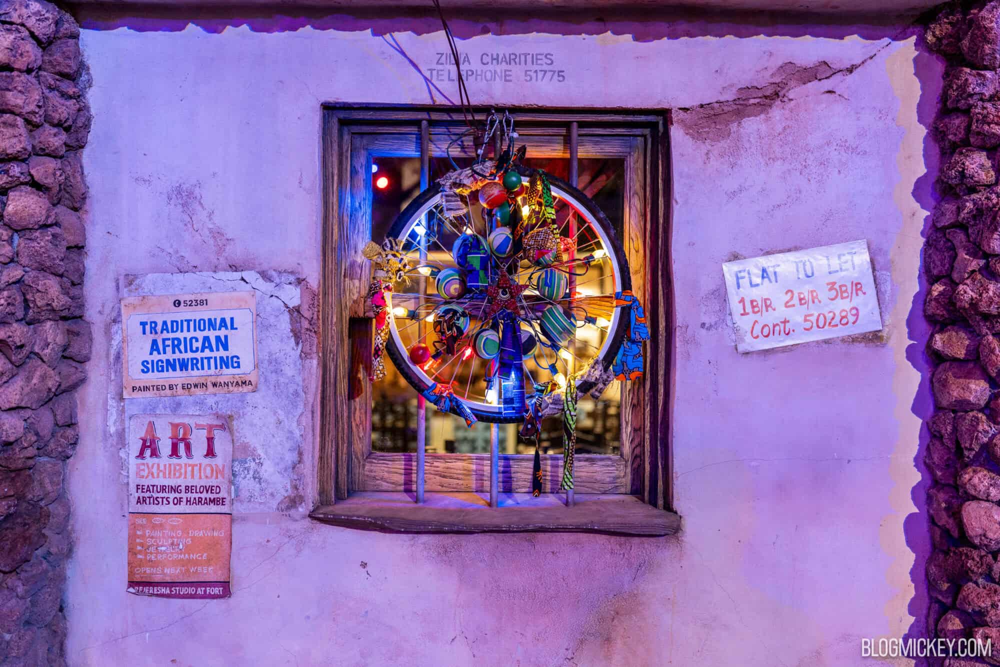 Colorful African art pieces displayed in a window during an art exhibition.
