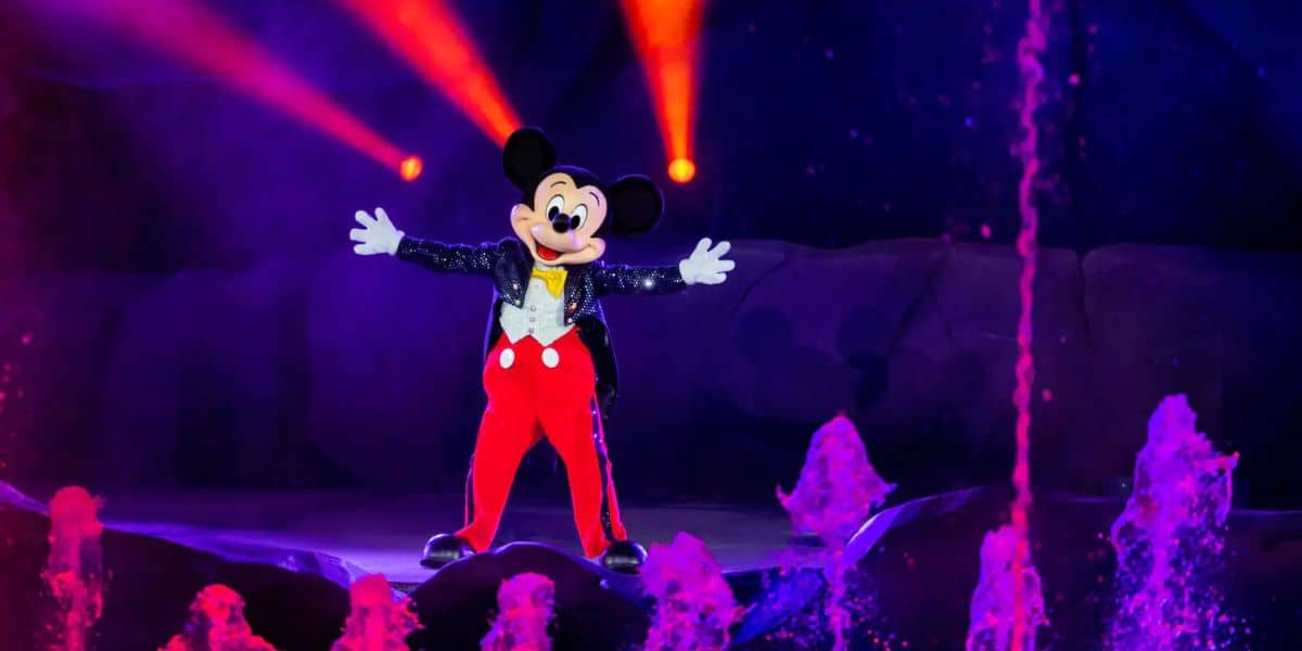 Mickey Mouse dances on stage at nighttime