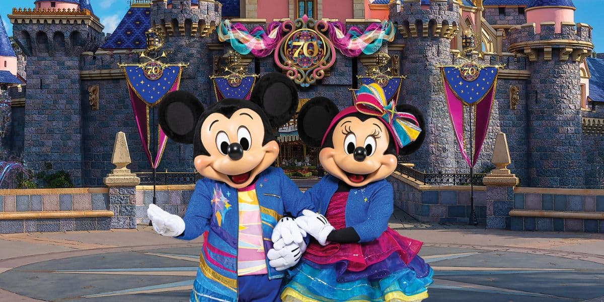 Mickey and Minnie Mouse in 70th anniversary outfits at Disneyland California as the Disney castle prepares for some major changes at this Disney Park crowds.