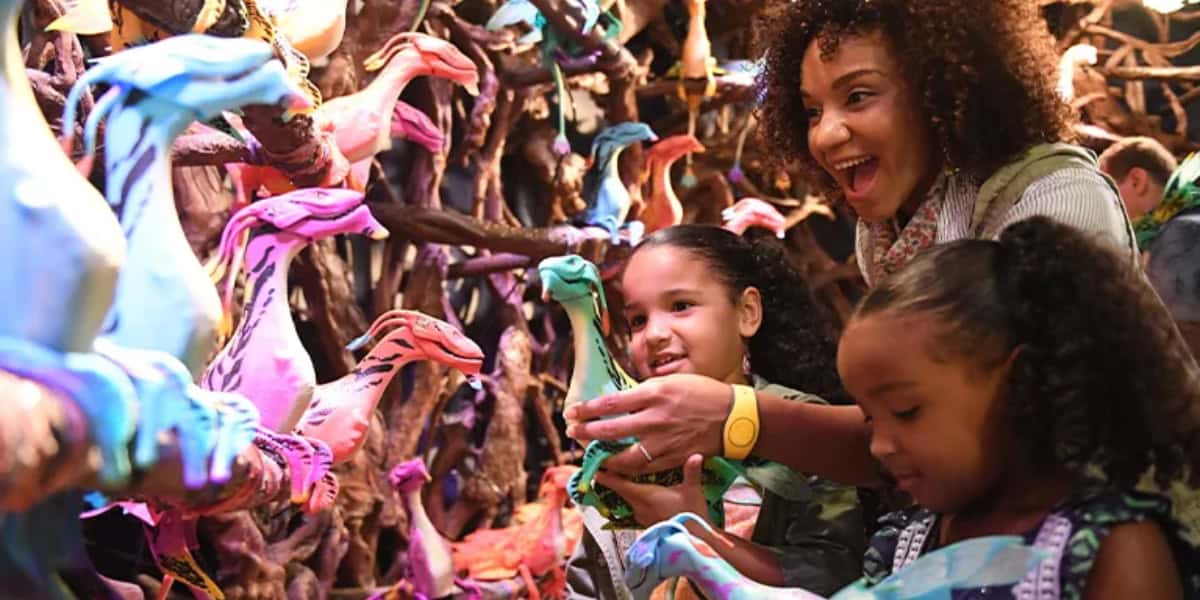 Guests at Animal Kingdom holding Banshee toys from Pandora: World of Avatar